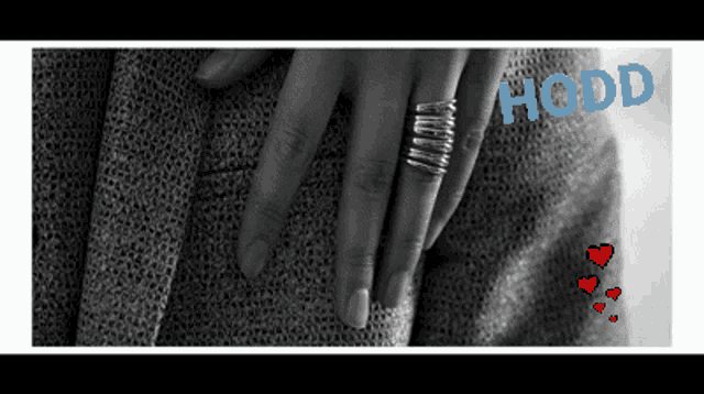 a black and white photo of a woman 's hand with the word hoddd on the bottom right