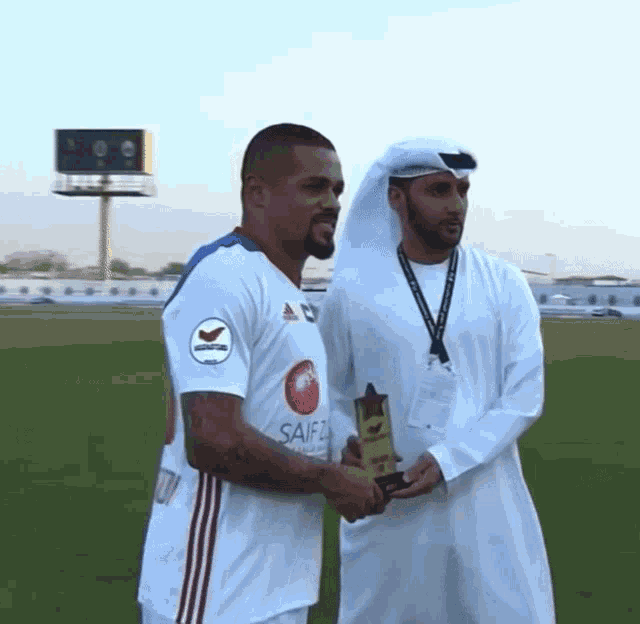 a man in a white shirt that says saifc on it