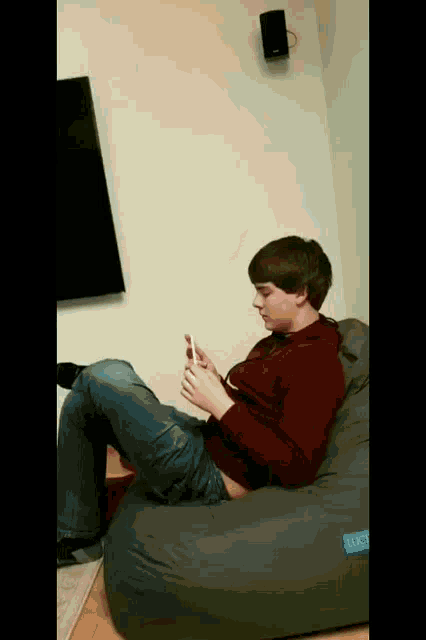 a boy sits on a bean bag chair that says lucy on the side