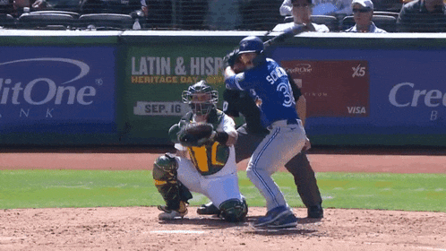 a baseball player is swinging at a pitch in front of a banner that says latin & hispanic
