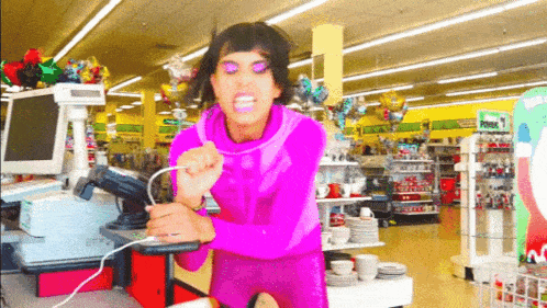 a woman in a pink outfit is singing into a microphone in a store with a sign that says price 1