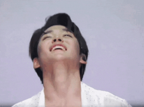 a close up of a man 's face with a smile on his face