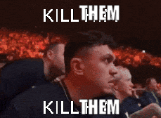 a man sitting in front of a crowd with the words kill them kill them written on his face
