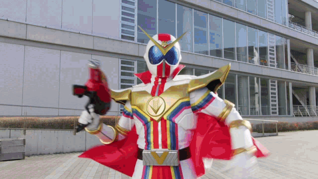a superhero is standing in front of a building and holding a gun