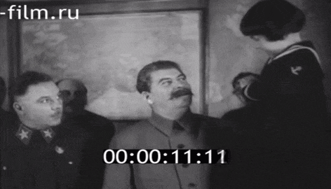 a black and white photo of a man with a mustache and a time of 11:11