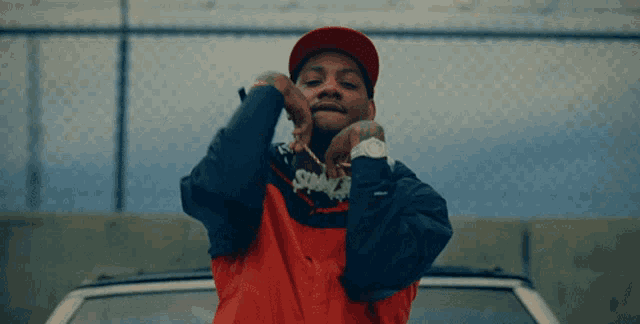 a man wearing a red hat and a jacket with the word swag on it