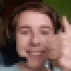 a pixelated image of a person 's face with their hand on their face