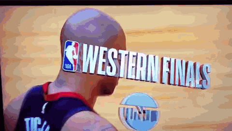 a bald man is playing basketball in front of a screen that says nba western finals
