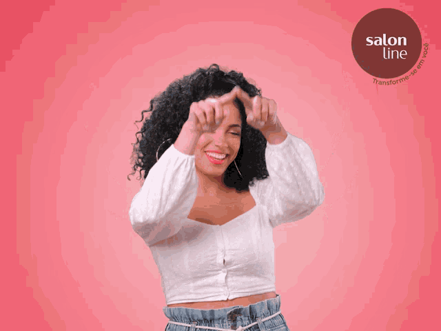 a woman with curly hair is holding a red arrow over her head in front of a logo for salon line