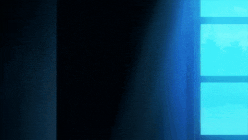 a blue light is coming through a window in a dark room .