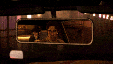 a man and a woman are reflected in a rear view mirror of a car