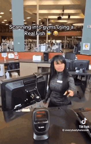 a woman is scanning into gyms using a real fish