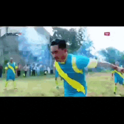 a man in a blue and yellow soccer uniform is running on the field