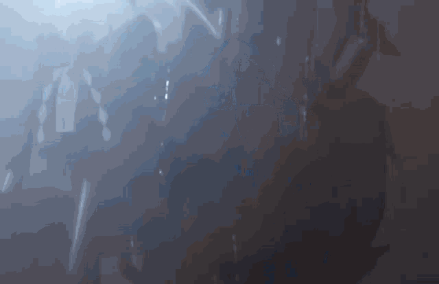 a blurred image of a person in a dark room with a sword