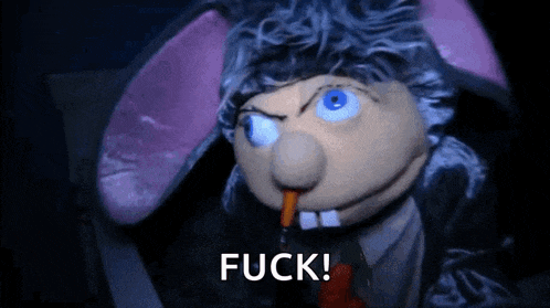 a puppet with bunny ears and a carrot in its mouth is saying fuck
