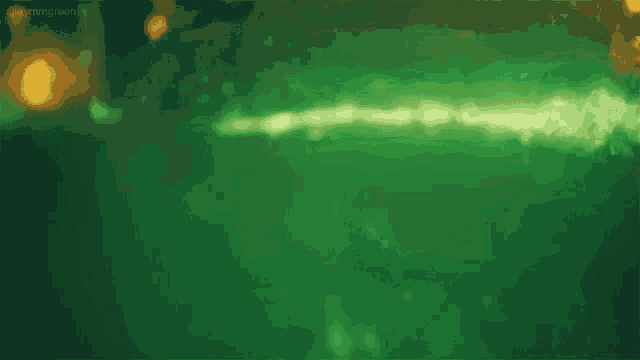 a green background with a blurred image of a person swimming in the water