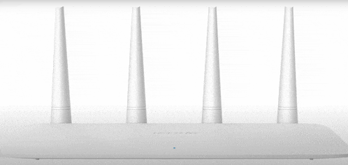 a white tp-link router is sitting on a table