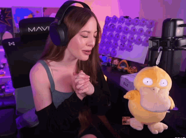 a woman wearing headphones sits in a mavi gaming chair