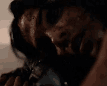 a close up of a man 's face with blood on it .