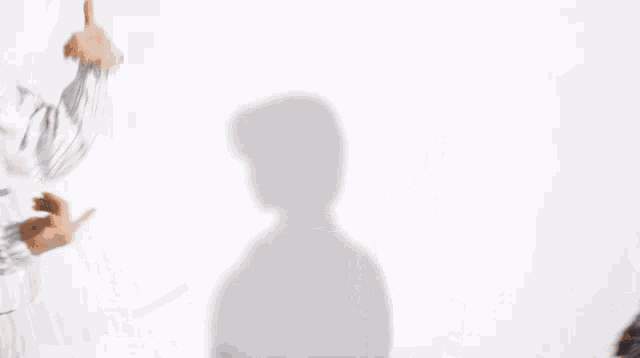a man and a woman are standing next to each other looking at each other .