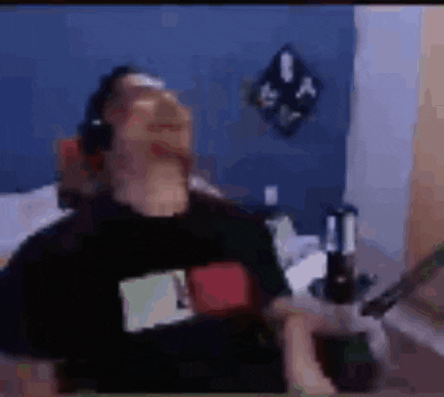 a blurry picture of a man wearing headphones and a black shirt