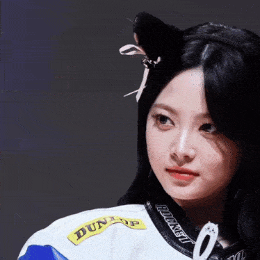 a woman wearing a dunlop jacket with a cat ear on her head