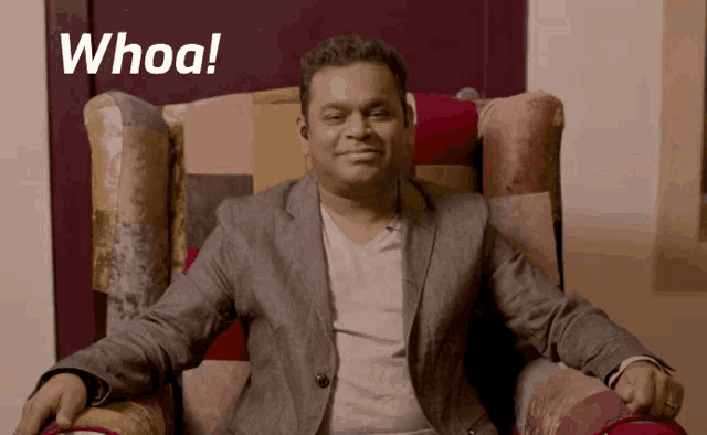 a man in a suit is sitting in a chair with the word whoa written on the bottom