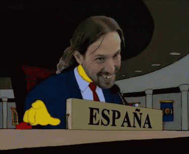 a man in a suit and tie is sitting at a table with a sign that says venezuela