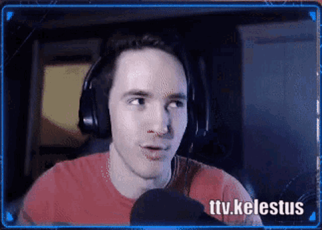 a man wearing headphones is talking into a microphone with the words ttv.kelestus behind him