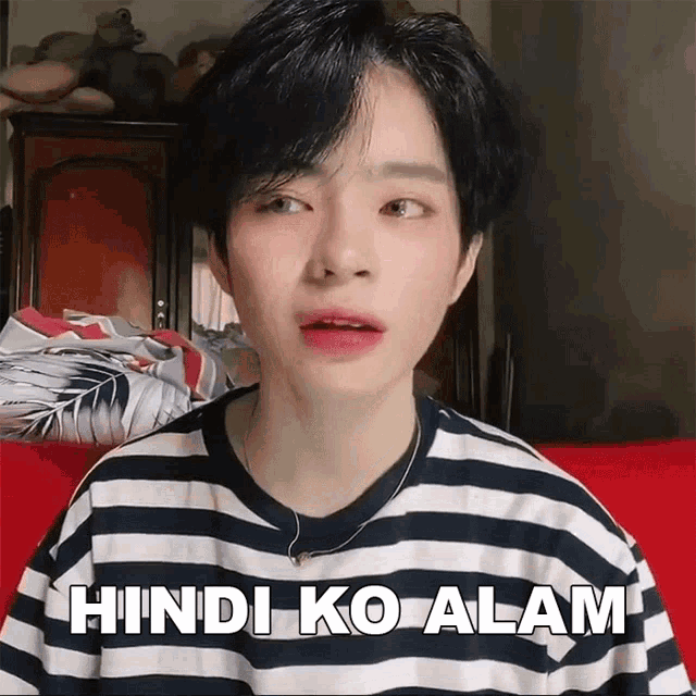 a person wearing a striped shirt with the words hindi ko alam written on it