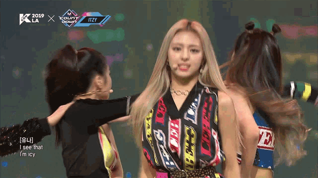 a girl in a colorful shirt stands in front of a sign that says ' i see that i m icy '