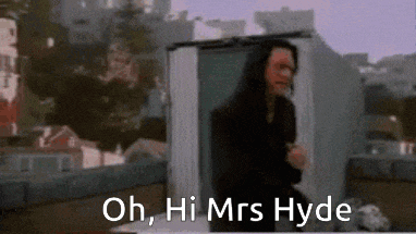 a blurry picture of a man sitting on a roof with the words oh hi mrs hyde above him .