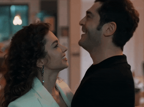 a man and a woman are looking at each other with their eyes closed