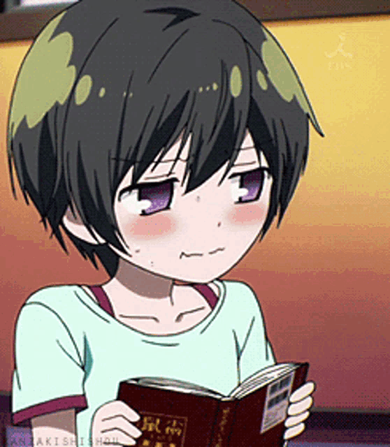 a girl with short black hair is reading a book with a red cover