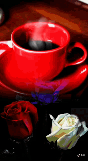 a red cup of coffee sits on a saucer next to a rose