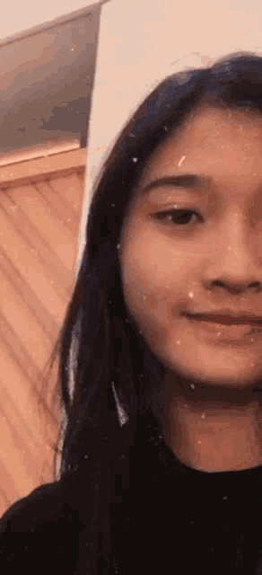 a close up of a woman 's face with a blurred background .