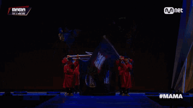a group of people are holding flags in front of a screen that says mama