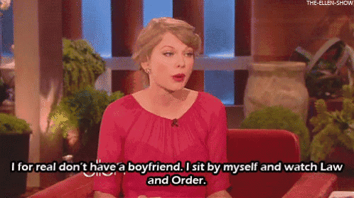 a woman in a pink shirt is sitting in a chair and saying i for real do n't have a boyfriend