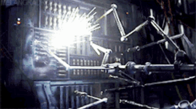 a machine with a lot of arms and a light coming out of it .
