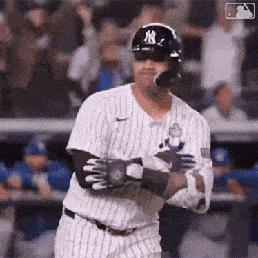 a baseball player is swinging his bat at a ball while wearing a helmet and sunglasses .
