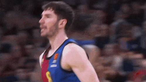 a basketball player wearing a jersey with the number 8 on it is standing on the court .