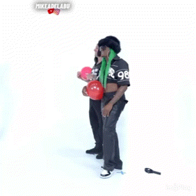 a man with the number 1 on his shirt is holding a woman in his arms