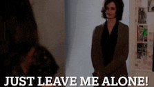 a woman is standing in front of a mirror with the words `` just leave me alone ! ''