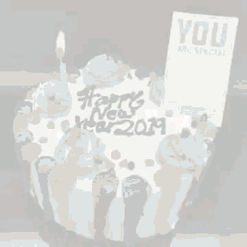 a birthday cake with a candle and a wishing card