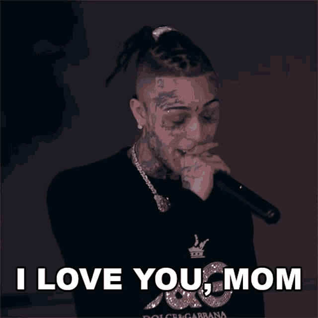 a man singing into a microphone with the words " i love you mom " above him