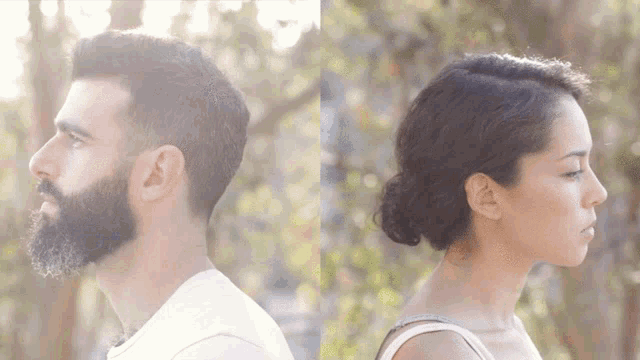 a man with a beard and a woman with a bun standing back to back