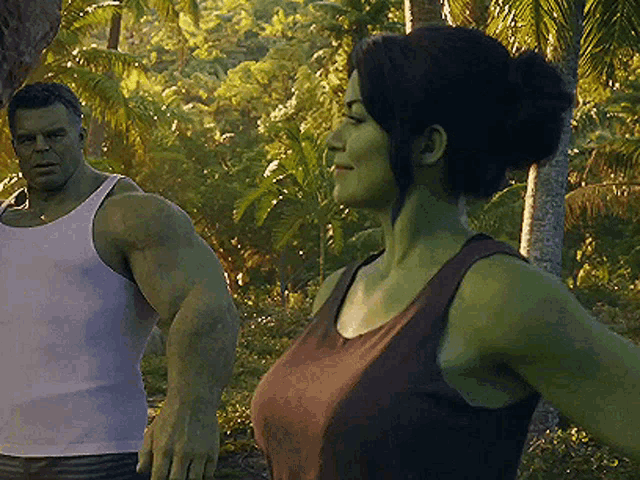 a man and a woman are standing next to each other in the jungle