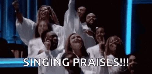 a group of people are singing praises in a church choir .