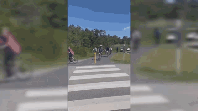 a group of people riding bikes on a road