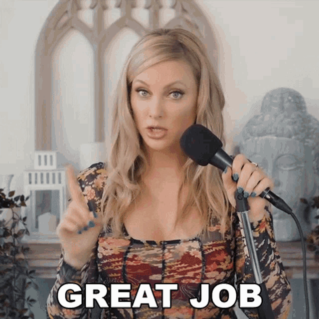 a woman singing into a microphone with the words great job written below her